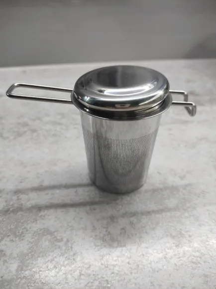 The steel basket with its lid on, standing on a grey stone counter. Photographed by N***o, a verified buyer